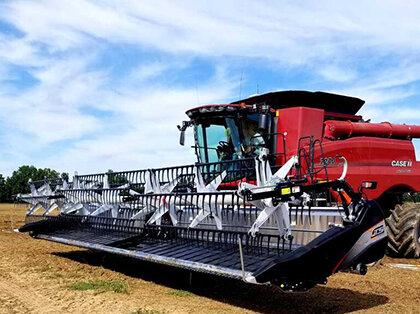 G T S draper head attached to a combine in a soybean field