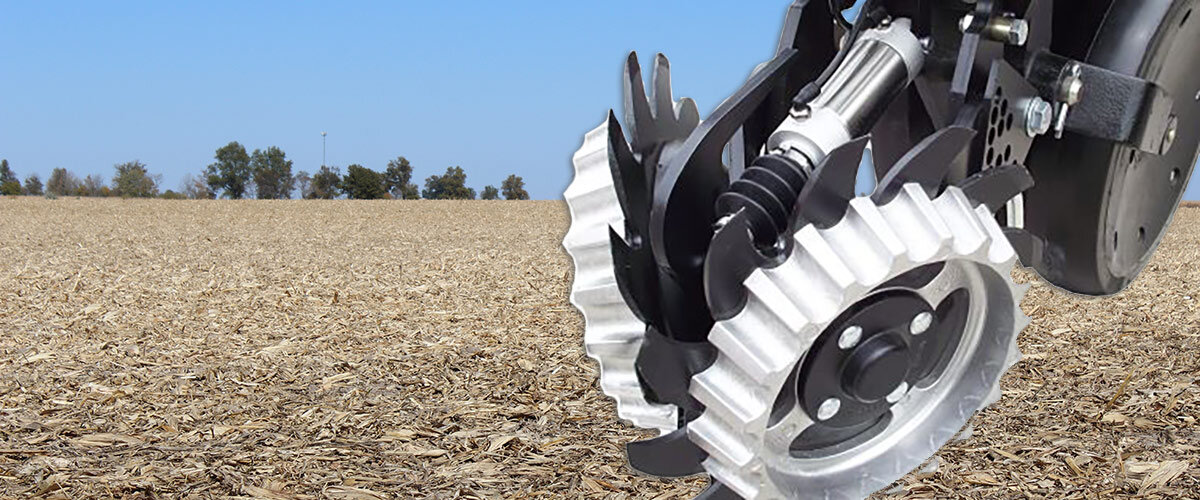 Clean Sweep Ready Floating Row Cleaner with a harvested corn field in the background